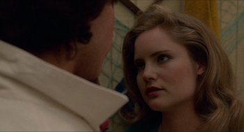 Movie still from “Fast Times at Ridgemont High” (1982), directed by Amy Heckerling – A woman looking into a mirror while standing next to a man; Close Up shot, Over the shoulder angle