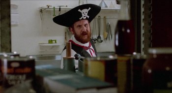 Movie still from “Fast Times at Ridgemont High” (1982), directed by Amy Heckerling – A man wearing a pirate's hat in a kitchen; Medium shot, Over the shoulder angle