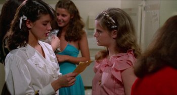 Movie still from “Fast Times at Ridgemont High” (1982), directed by Amy Heckerling – A group of young women standing next to each other in a room; Medium shot, Over the shoulder angle