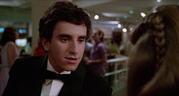 Movie still from “Fast Times at Ridgemont High” (1982), directed by Amy Heckerling – A man in a tuxedo is looking at the camera; Close Up shot, Over the shoulder angle