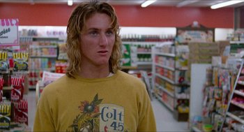 Movie still from “Fast Times at Ridgemont High” (1982), directed by Amy Heckerling – A man with long blonde hair wearing a yellow shirt in a grocery store; Close Up shot, Low angle