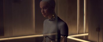 Movie still from “Ex Machina” (2014), directed by Alex Garland – A woman is standing in front of a mirror; Close Up shot, Over the shoulder angle