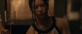 Movie still from “Ex Machina” (2014), directed by Alex Garland – A woman with long black hair is looking at the camera; Close Up shot, Low angle