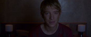 Movie still from “Ex Machina” (2014), directed by Alex Garland – A person wearing a red shirt; Close Up shot, Over the shoulder angle