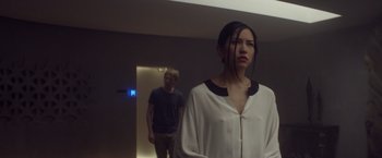 Movie still from “Ex Machina” (2014), directed by Alex Garland – A man and a woman standing in front of each other; Medium shot, Low angle
