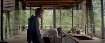 Movie still from “Ex Machina” (2014), directed by Alex Garland – Two men are standing in front of a sink; Wide shot, Low angle