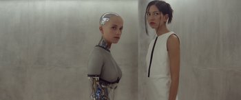 Movie still from “Ex Machina” (2014), directed by Alex Garland – Two women standing next to each other in front of a wall; Close Up shot, Low angle