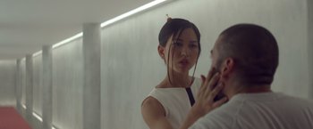 Movie still from “Ex Machina” (2014), directed by Alex Garland – A woman is looking in the mirror while brushing her hair; Close Up shot, Over the shoulder angle