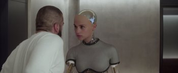 Movie still from “Ex Machina” (2014), directed by Alex Garland – A woman in a see - through dress and a man in a white shirt; Close Up shot, Over the shoulder angle