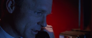 Movie still from “Glengarry Glen Ross” (1992), directed by James Foley – A person talking on a phone; Extreme Close Up shot, Low angle