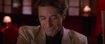 Movie still from “Glengarry Glen Ross” (1992), directed by James Foley – A person wearing a suit and tie; Close Up shot, High angle