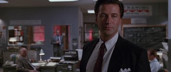 Movie still from “Glengarry Glen Ross” (1992), directed by James Foley – A man wearing a suit and tie in a room; Medium shot, Low angle
