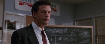 Movie still from “Glengarry Glen Ross” (1992), directed by James Foley – A person wearing a suit and tie; Close Up shot, Over the shoulder angle