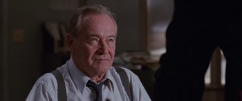 Movie still from “Glengarry Glen Ross” (1992), directed by James Foley – An older man wearing a neck tie looking at the camera; Close Up shot, Low angle