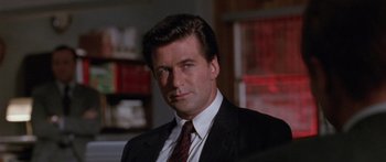 Movie still from “Glengarry Glen Ross” (1992), directed by James Foley – A person wearing a suit and tie; Close Up shot, Low angle
