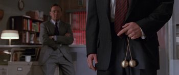 Movie still from “Glengarry Glen Ross” (1992), directed by James Foley – A man in a suit and tie standing next to another man in a suit and tie; Extreme Close Up shot, Overhead angle