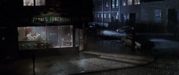 Movie still from “Glengarry Glen Ross” (1992), directed by James Foley – A night scene of an empty city street; Extreme Wide shot, High angle