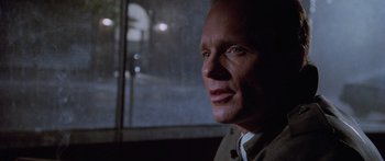 Movie still from “Glengarry Glen Ross” (1992), directed by James Foley – A person wearing a suit and tie; Close Up shot, Over the shoulder angle