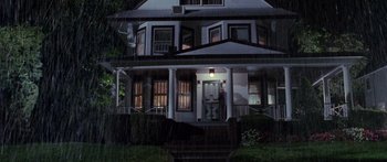Movie still from “Glengarry Glen Ross” (1992), directed by James Foley – A night time picture of a house in the rain; Extreme Wide shot, High angle