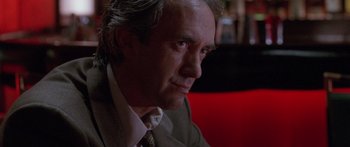 Movie still from “Glengarry Glen Ross” (1992), directed by James Foley – A person wearing a suit and tie; Close Up shot, Low angle