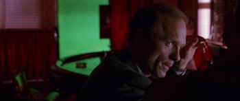 Movie still from “Glengarry Glen Ross” (1992), directed by James Foley – A person sitting at a table; Close Up shot, Low angle