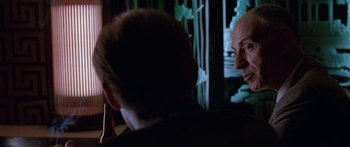 Movie still from “Glengarry Glen Ross” (1992), directed by James Foley – Two men sitting in front of each other in a room; Close Up shot, Over the shoulder angle
