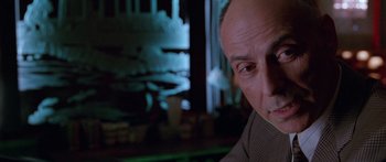 Movie still from “Glengarry Glen Ross” (1992), directed by James Foley – A person smoking a cigarette; Close Up shot, Low angle