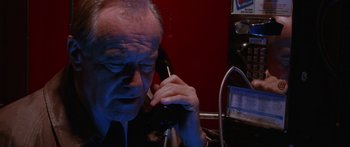 Movie still from “Glengarry Glen Ross” (1992), directed by James Foley – An older man talking on a phone while sitting at a desk; Close Up shot, Low angle
