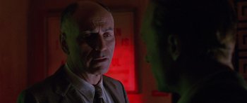 Movie still from “Glengarry Glen Ross” (1992), directed by James Foley – A man in a suit and tie looking at another man in a suit and tie; Close Up shot, Low angle