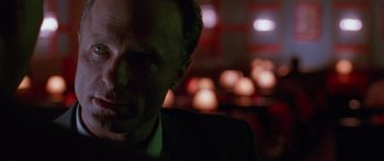 Movie still from “Glengarry Glen Ross” (1992), directed by James Foley – A person wearing a suit and tie; Close Up shot, Over the shoulder angle