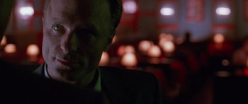 Movie still from “Glengarry Glen Ross” (1992), directed by James Foley – A person wearing a suit in a room; Close Up shot, Low angle