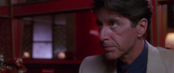 Movie still from “Glengarry Glen Ross” (1992), directed by James Foley – A person wearing a suit and tie; Close Up shot, Over the shoulder angle
