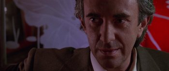Movie still from “Glengarry Glen Ross” (1992), directed by James Foley – A man's face in a suit and tie; Extreme Close Up shot, Low angle