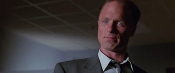 Movie still from “Glengarry Glen Ross” (1992), directed by James Foley – A man in a gray suit and white tie; Close Up shot, Low angle