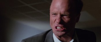 Movie still from “Glengarry Glen Ross” (1992), directed by James Foley – A man in a suit and tie with his mouth wide open; Close Up shot, Low angle