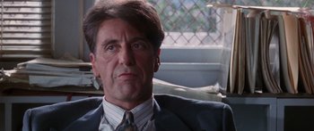 Movie still from “Glengarry Glen Ross” (1992), directed by James Foley – A person wearing a suit and tie; Close Up shot, Low angle