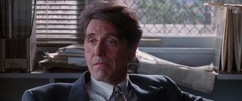 Movie still from “Glengarry Glen Ross” (1992), directed by James Foley – A person wearing a suit and tie; Close Up shot, Over the shoulder angle