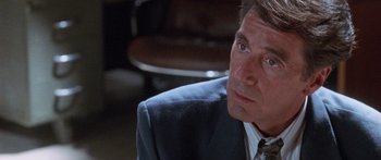 Movie still from “Glengarry Glen Ross” (1992), directed by James Foley – A person wearing a suit and tie; Close Up shot, Over the shoulder angle