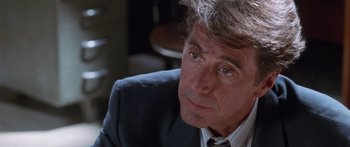 Movie still from “Glengarry Glen Ross” (1992), directed by James Foley – A person wearing a suit and tie; Close Up shot, Over the shoulder angle