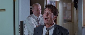 Movie still from “Glengarry Glen Ross” (1992), directed by James Foley – A man in a business suit and a bald man in a suit; Close Up shot, Low angle