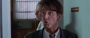 Movie still from “Glengarry Glen Ross” (1992), directed by James Foley – A man in a suit and tie looking surprised; Close Up shot, Low angle