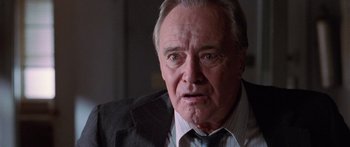 Movie still from “Glengarry Glen Ross” (1992), directed by James Foley – An older man wearing a suit and tie; Close Up shot, Low angle