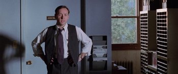 Movie still from “Glengarry Glen Ross” (1992), directed by James Foley – Kevin spacey in a suit and tie standing in a room; Medium shot, Low angle