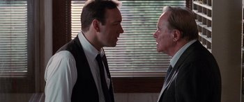 Movie still from “Glengarry Glen Ross” (1992), directed by James Foley – Two men in business suits face each other in front of a window; Close Up shot, Over the shoulder angle