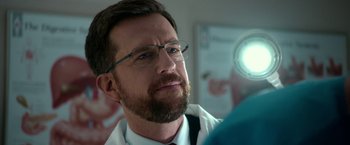 Movie still from “Father Figures” (2017), directed by Lawrence Sher – A person wearing glasses and a tie; Close Up shot, Over the shoulder angle