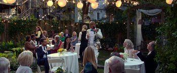 Movie still from “Father Figures” (2017), directed by Lawrence Sher – A group of people sitting around a table; Wide shot, Over the shoulder angle