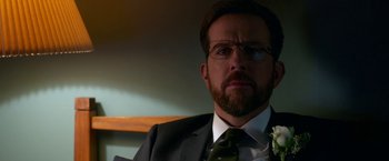 Movie still from “Father Figures” (2017), directed by Lawrence Sher – A person wearing a suit and tie; Close Up shot, Over the shoulder angle