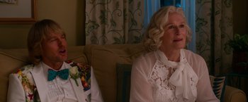 Movie still from “Father Figures” (2017), directed by Lawrence Sher – An older woman sitting on a couch in front of a window; Close Up shot, Over the shoulder angle