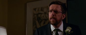 Movie still from “Father Figures” (2017), directed by Lawrence Sher – A person wearing a suit and glasses; Close Up shot, Over the shoulder angle