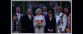 Movie still from “Father Figures” (2017), directed by Lawrence Sher – A family posing for a wedding picture; Wide shot, Over the shoulder angle